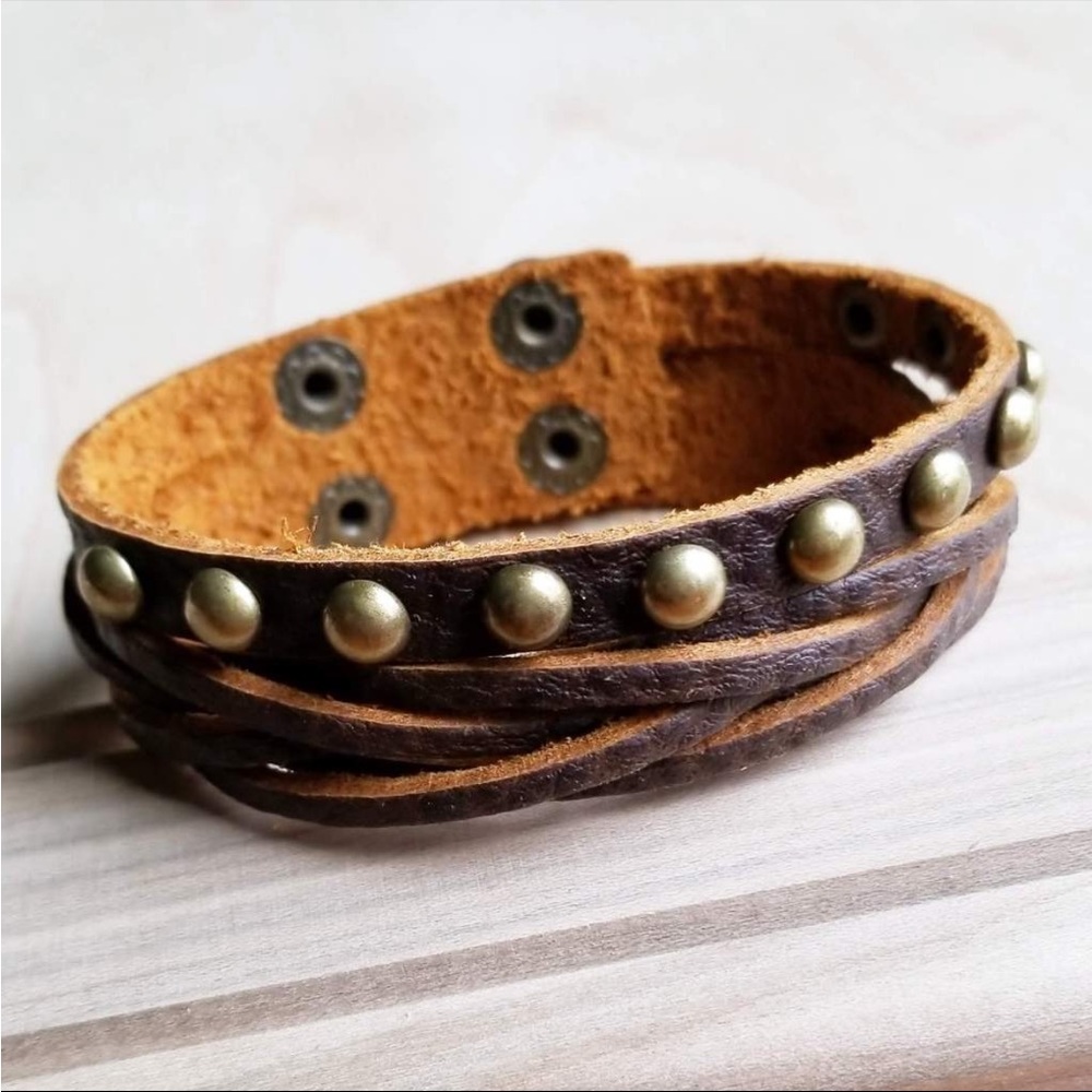 Genuine Leather Multi-Strand Cuff
features antique gold studs.